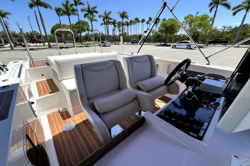 Slide: The Image of 2013 Novurania Chase 23 boat interior with plush seating and modern controls. - 66