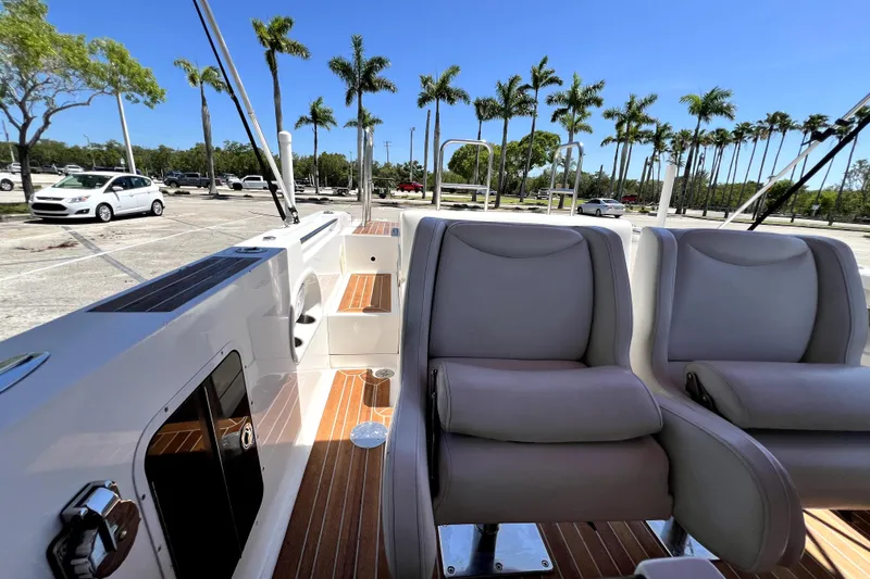 Slide: The Image of 2013 Novurania Chase 23 boat interior with plush seating and wooden deck. - 67