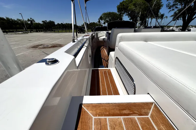 Slide: The Image of 2013 Novurania Chase 23 boat interior with white seating and wooden flooring. - 80