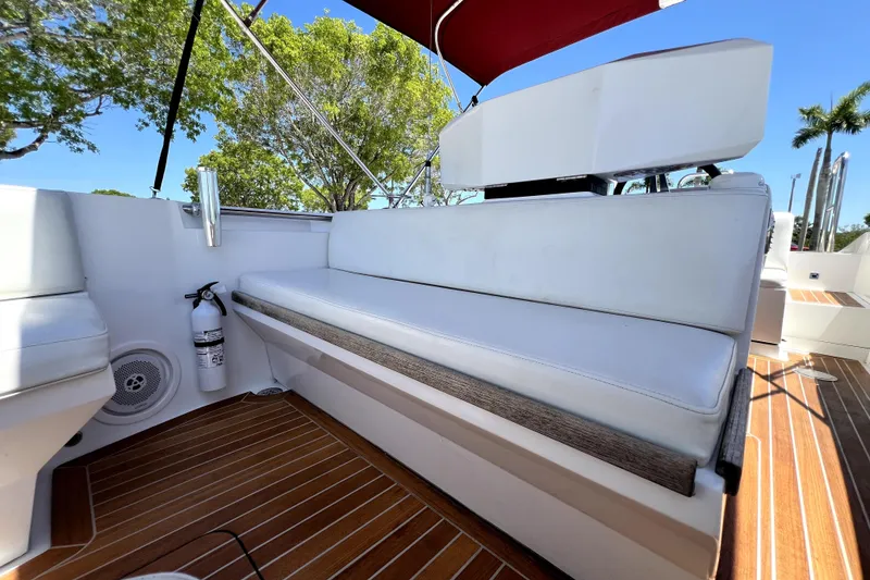 Slide: The Image of 2013 Novurania Chase 23 boat interior with white seating and wooden flooring. - 37