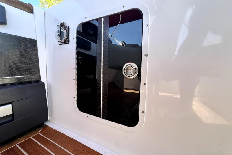 Slide: The Image of 2013 Novurania Chase 23 boat cabin door with sleek design and secure latch. - 50