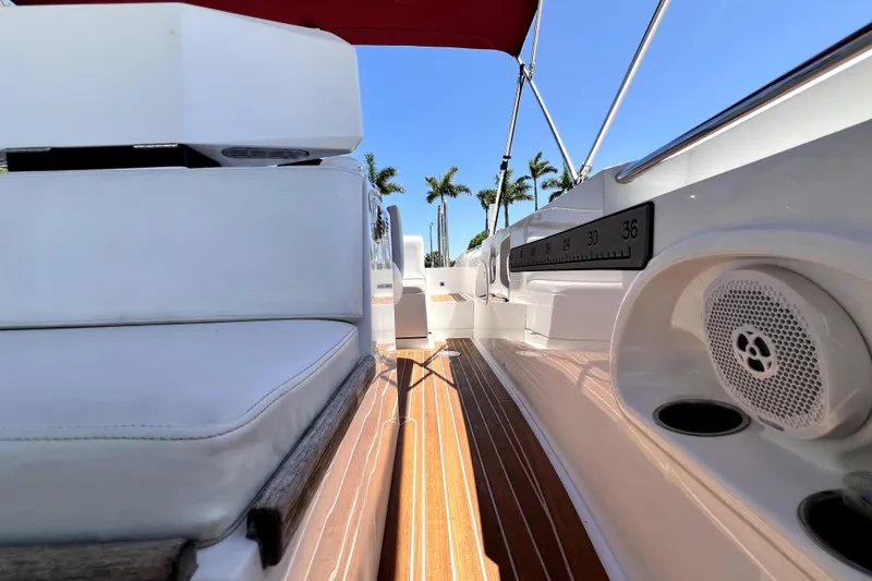 Slide: The Image of 2013 Novurania Chase 23 boat interior with teak flooring and white seating. - 57