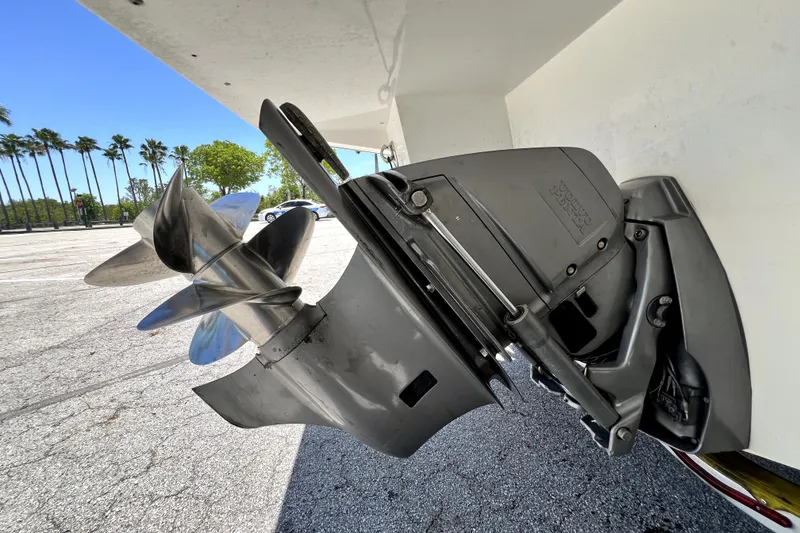 Slide: The Image of 2013 Novurania Chase 23 boat propeller and outboard motor in a sunny parking lot. - 7