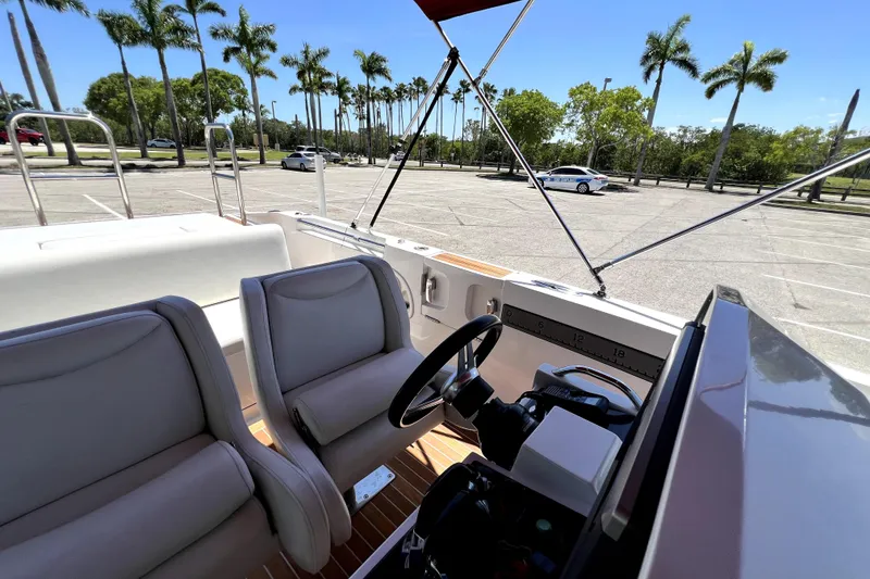 Slide: The Image of Interior view of 2013 Novurania Chase 23 boat with steering wheel and seats. - 65