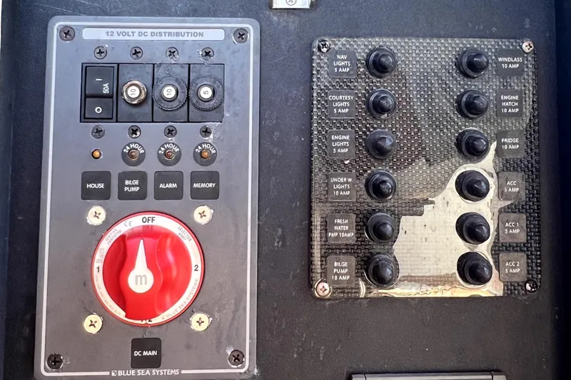 Slide: The Image of Control panel of a 2013 Novurania Chase 23 boat with labeled switches and dials. - 82