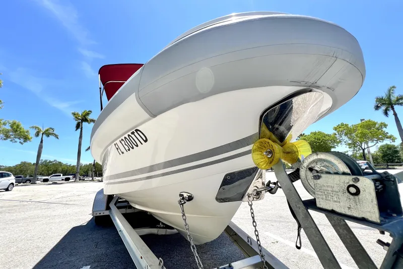 Slide: The Image of 2013 Novurania Chase 23 boat on trailer under clear blue sky. - 23
