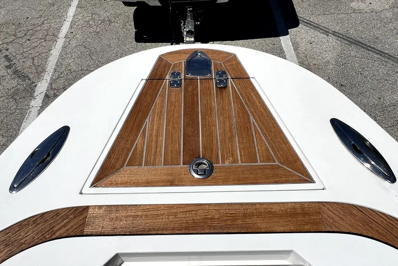 Slide: The Image of 2013 Novurania Chase 23 boat deck with wood paneling and metal fixtures. - 64
