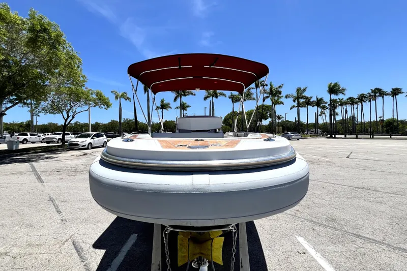 Slide: The Image of 2013 Novurania Chase 23 boat with canopy in sunny parking lot. - 20