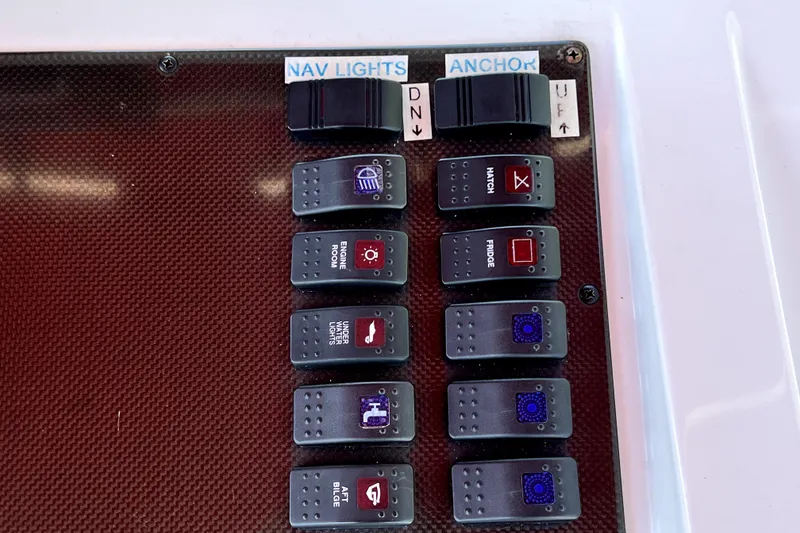 Slide: The Image of Control panel of a 2013 Novurania Chase 23 boat with labeled switches. - 74