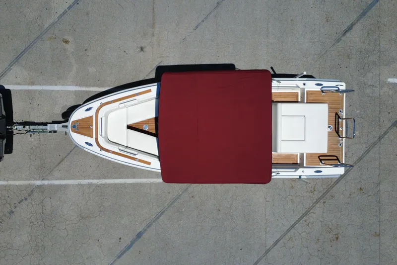 Slide: The Image of Aerial view of 2013 Novurania Chase 23 boat with red canopy on trailer. - 26