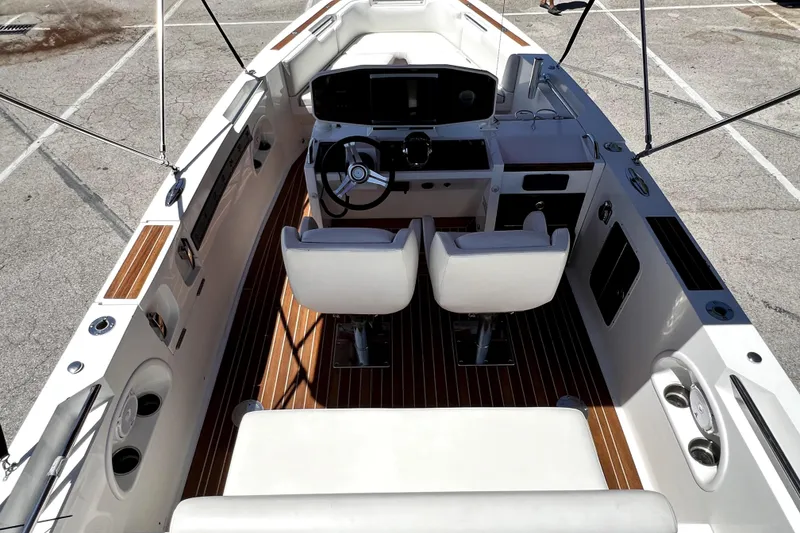 Slide: The Image of 2013 Novurania Chase 23 boat interior with dual seats and sleek dashboard design. - 81