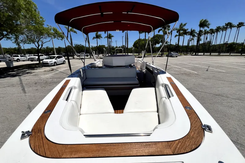 Slide: The Image of 2013 Novurania Chase 23 boat with canopy, parked in sunny lot with palm trees. - 33