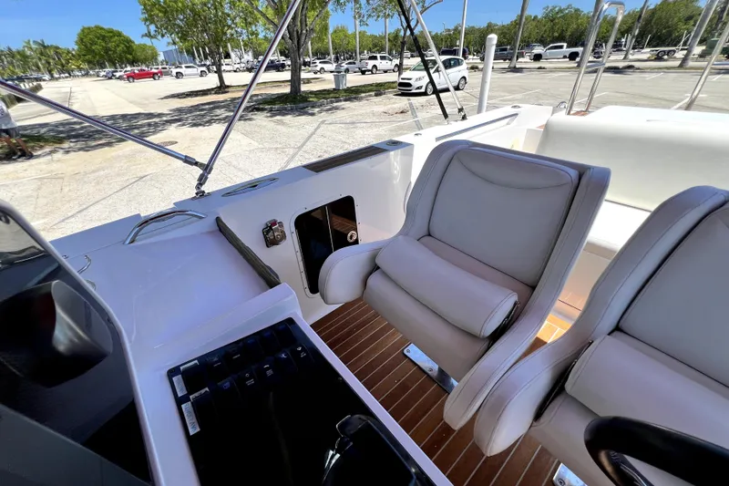 Slide: The Image of 2013 Novurania Chase 23 boat interior with plush seating and control panel. - 49