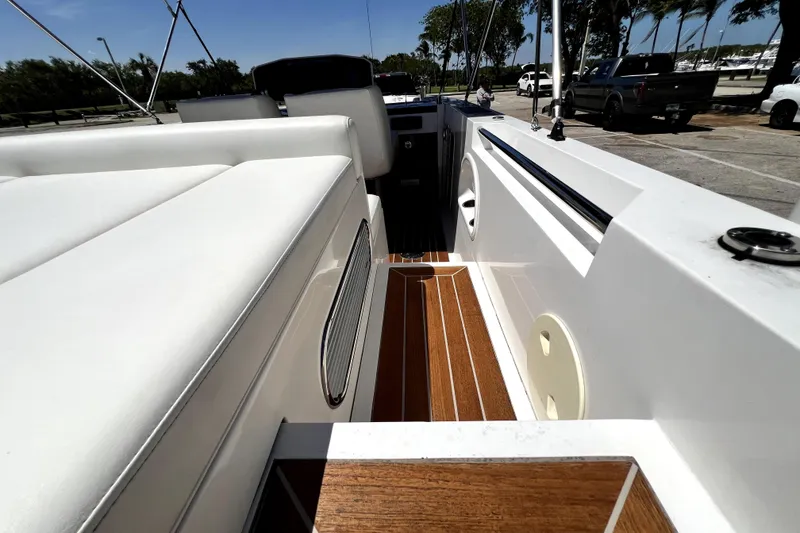 Slide: The Image of 2013 Novurania Chase 23 boat interior with white seating and wooden flooring. - 69