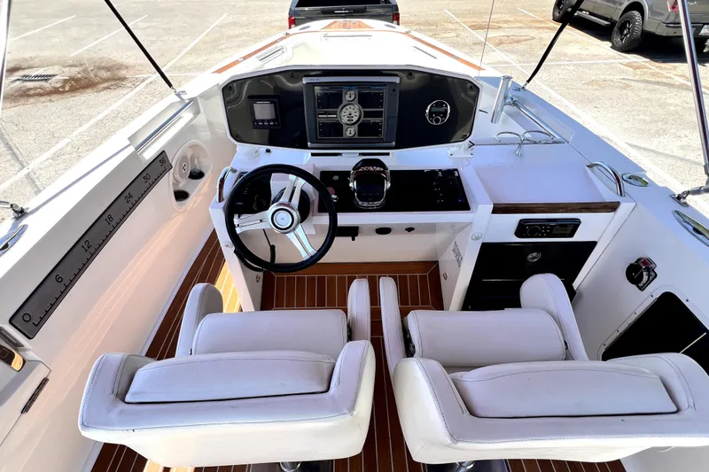 Slide: The Image of Interior view of 2013 Novurania Chase 23 boat cockpit with steering wheel and controls. - 41