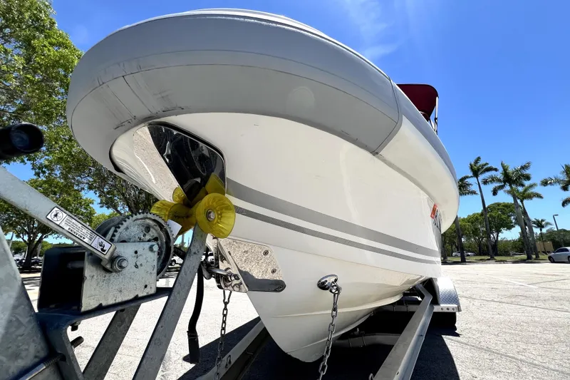 Slide: The Image of 2013 Novurania Chase 23 boat on trailer under clear blue sky. - 18