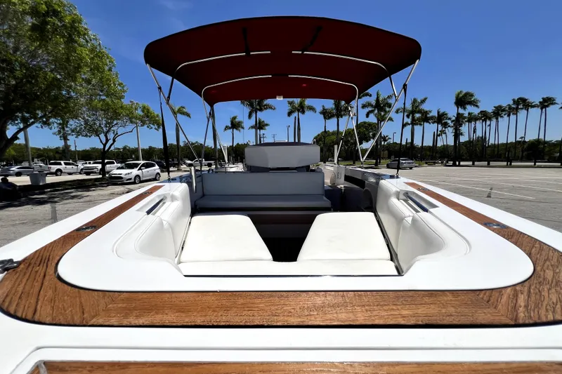 Slide: The Image of 2013 Novurania Chase 23 boat with red canopy, parked under clear blue sky. - 36