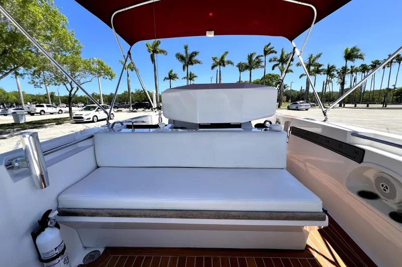 Slide: The Image of 2013 Novurania Chase 23 boat interior with white seating and red canopy. - 56