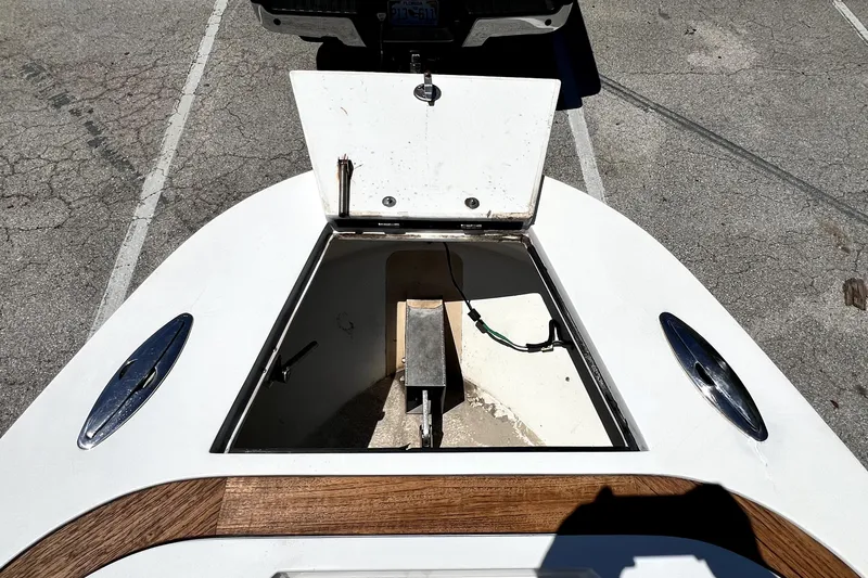 Slide: The Image of Open storage compartment on 2013 Novurania Chase 23 boat, parked on asphalt. - 53