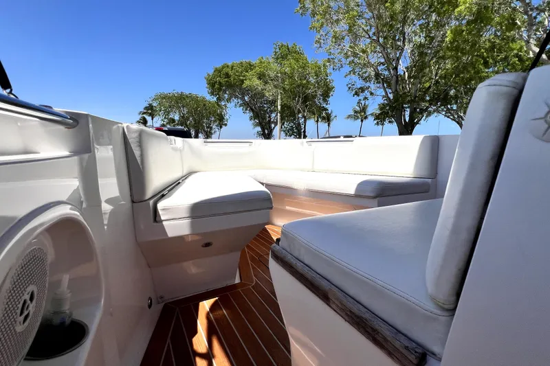 Slide: The Image of 2013 Novurania Chase 23 boat interior with white seating and wooden flooring. - 43