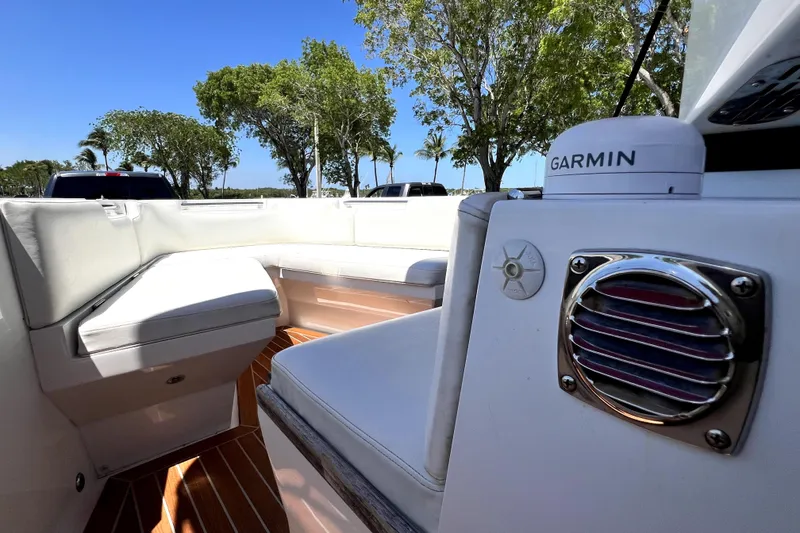 Slide: The Image of 2013 Novurania Chase 23 boat interior with white seating and Garmin equipment. - 47
