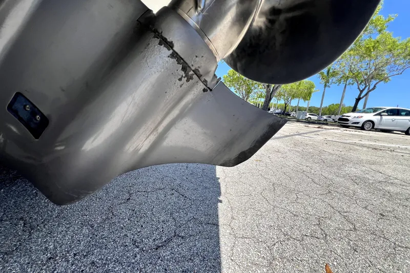 Slide: The Image of Close-up of a 2013 Novurania Chase 23 boat propeller in a parking lot. - 10