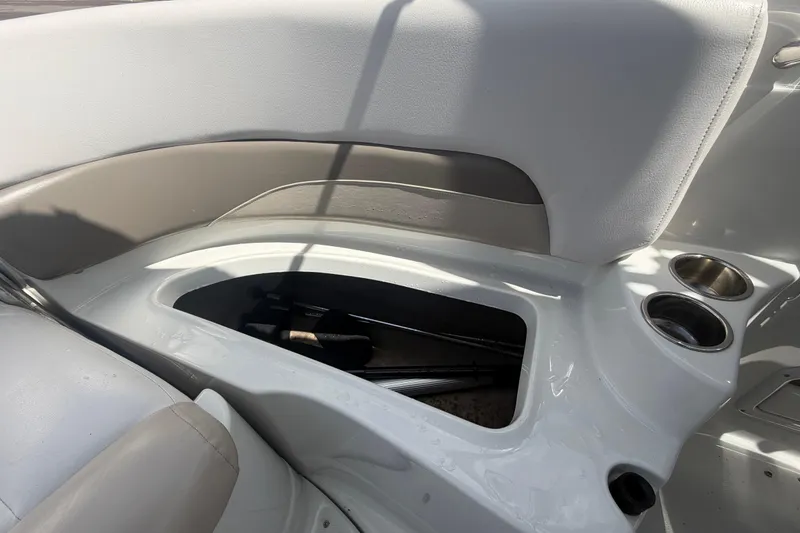 Slide: The Image of Interior of 2012 Crownline 236 SC boat showing storage compartment and cup holders. - 85