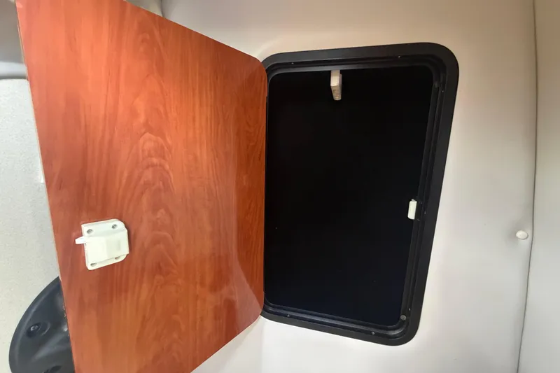 Slide: The Image of Open wooden cabinet door inside 2012 Crownline 236 SC boat interior. - 69