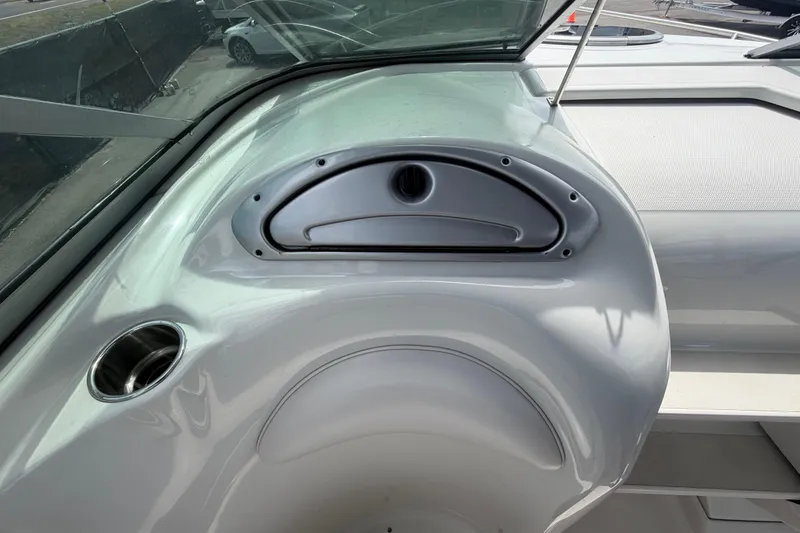Slide: The Image of 2012 Crownline 236 SC boat interior detail with cup holder and storage compartment. - 49