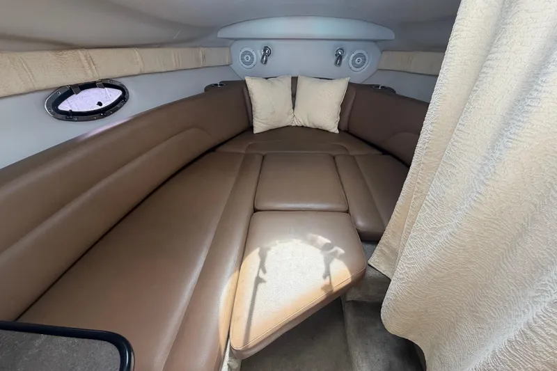Slide: The Image of Interior cabin of 2012 Crownline 236 SC boat with brown seating and pillows. - 54