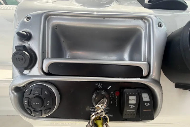 Slide: The Image of Control panel of a 2012 Crownline 236 SC boat with switches and key ignition. - 41