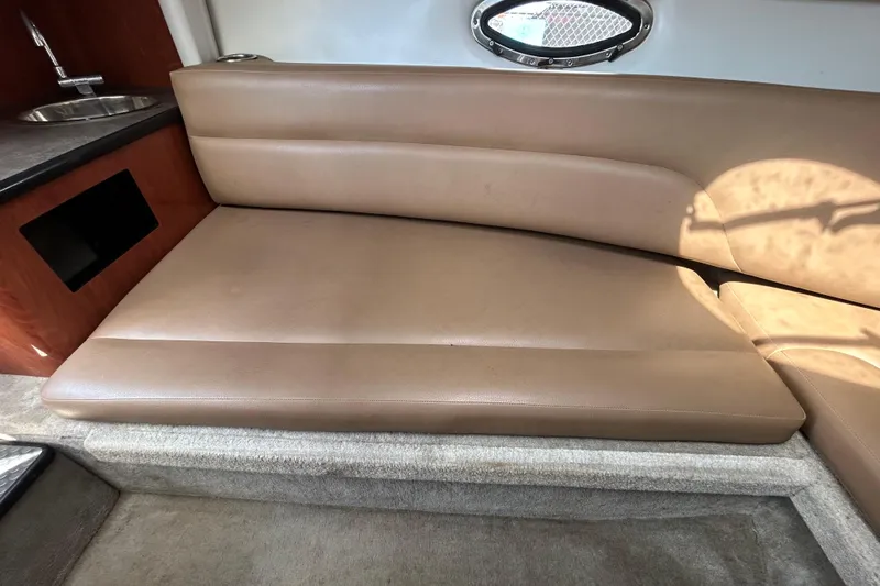 Slide: The Image of Interior of 2012 Crownline 236 SC boat with tan leather seating and small sink. - 56