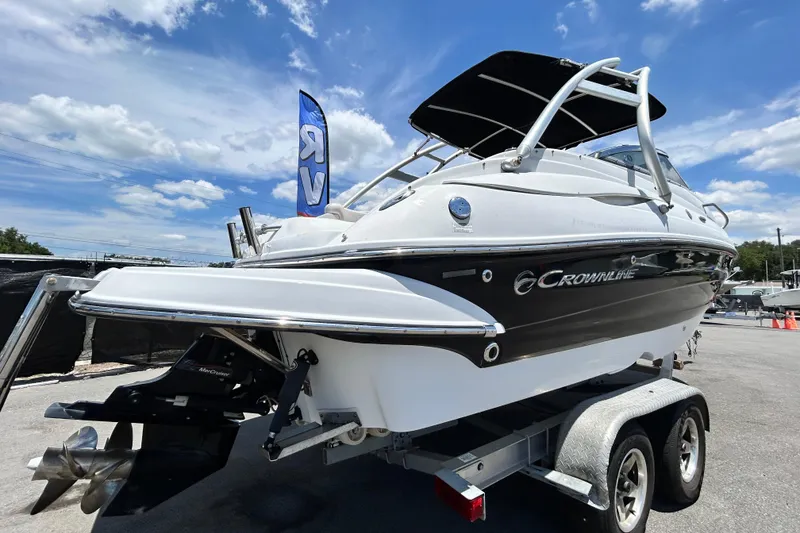 Slide: The Image of 2012 Crownline 236 SC boat on trailer under blue sky. - 2