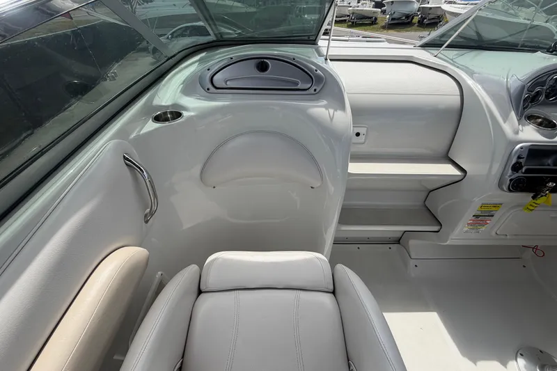 Slide: The Image of Interior of a 2012 Crownline 236 SC boat, featuring seating and dashboard details. - 48