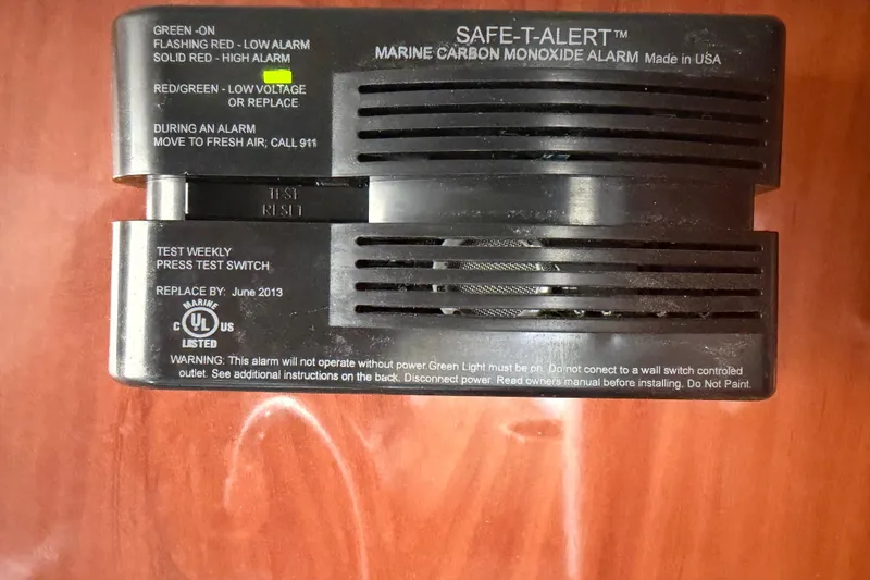 Slide: The Image of Marine carbon monoxide alarm on Crownline 236 SC, 2012 model, with safety instructions. - 60