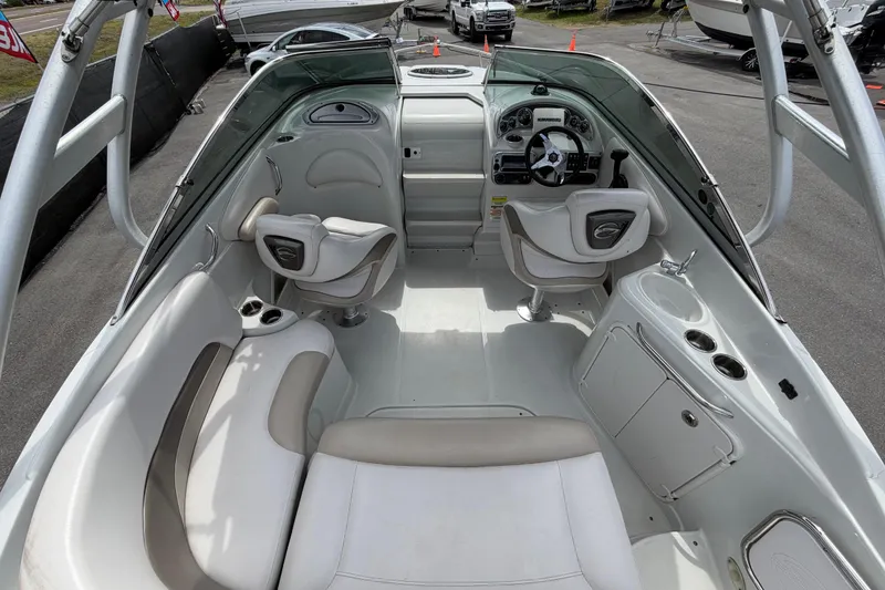 Slide: The Image of Interior of a 2012 Crownline 236 SC boat, featuring seating and helm controls. - 22