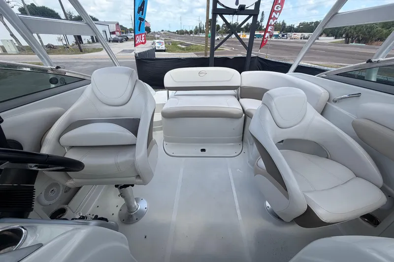 Slide: The Image of Interior of a 2012 Crownline 236 SC boat with white seating and steering wheel. - 79