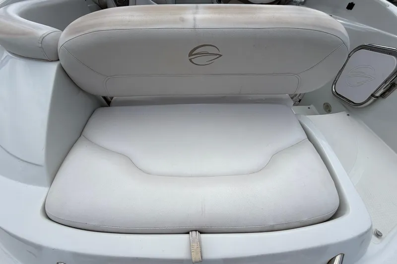 Slide: The Image of Crownline 236 SC 2012 boat seat with white upholstery and logo detail. - 16