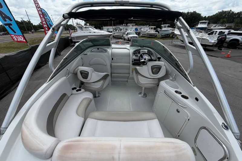 Slide: The Image of 2012 Crownline 236 SC boat interior with seating, steering wheel, and dashboard. - 20