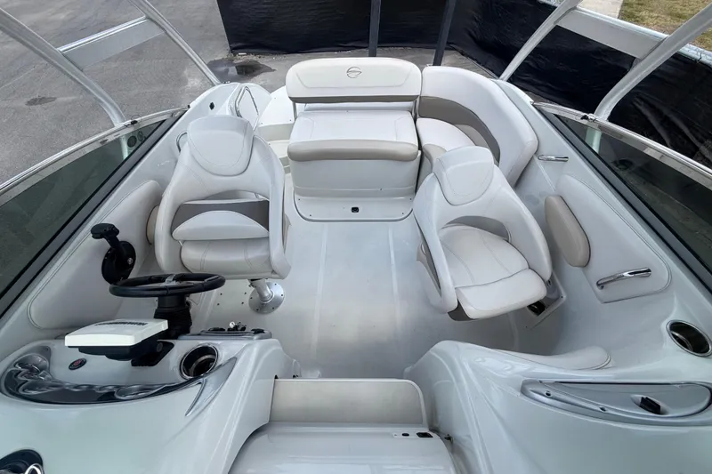 Slide: The Image of Interior of 2012 Crownline 236 SC boat with white seating and steering console. - 78