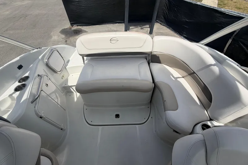 Slide: The Image of 2012 Crownline 236 SC boat interior with white seating and storage compartments. - 83