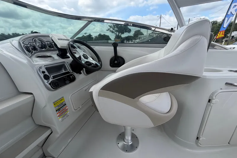 Slide: The Image of 2012 Crownline 236 SC boat cockpit with steering wheel and captain's chair. - 45