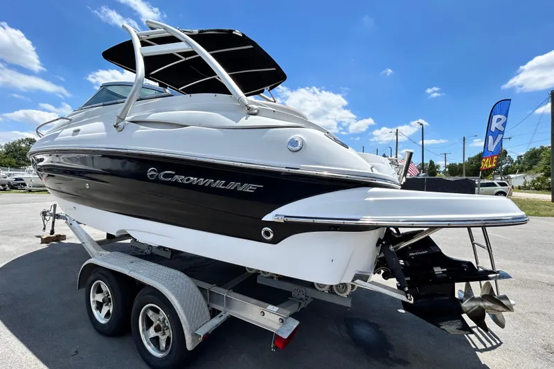 Slide: The Image of 2012 Crownline 236 SC boat on trailer under clear blue sky. - 7