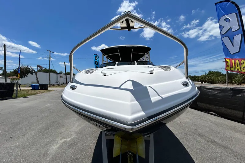 Slide: The Image of 2012 Crownline 236 SC boat displayed outdoors under a clear blue sky. - 10