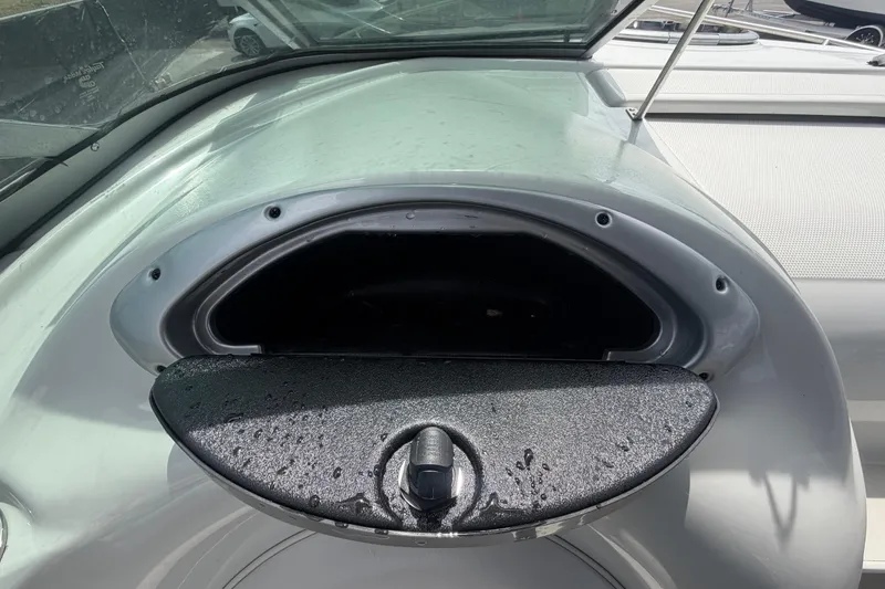 Slide: The Image of Crownline 236 SC 2012 boat compartment with open hatch, showing interior storage space. - 50