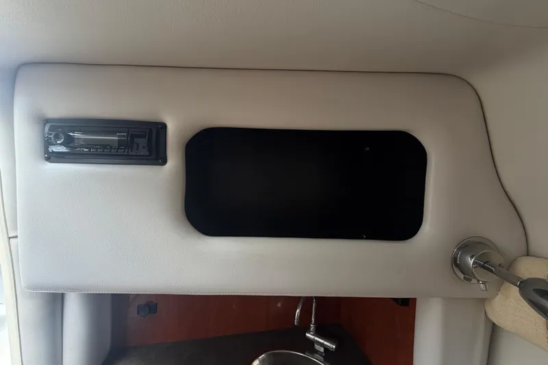 Slide: The Image of Interior of 2012 Crownline 236 SC boat with stereo system and sink. - 62
