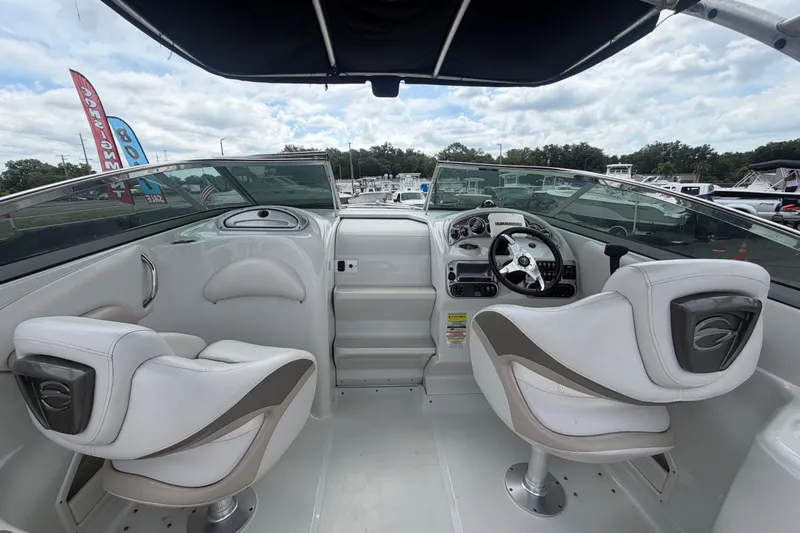 Slide: The Image of Interior view of 2012 Crownline 236 SC boat with white seating and dashboard. - 30