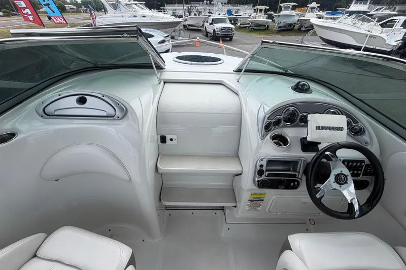 Slide: The Image of Interior view of 2012 Crownline 236 SC boat cockpit with steering wheel and dashboard. - 32