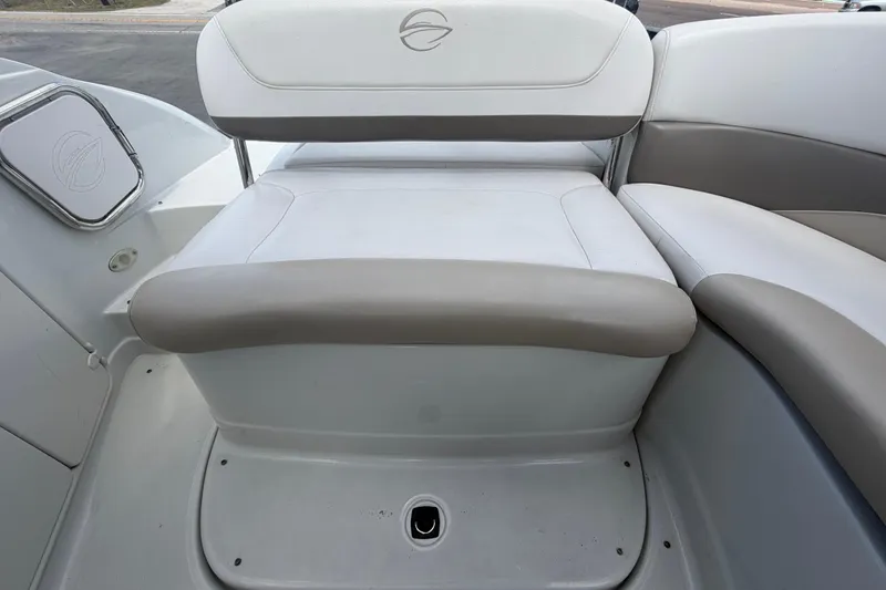 Slide: The Image of Interior seating of 2012 Crownline 236 SC boat, featuring white and gray upholstery. - 87