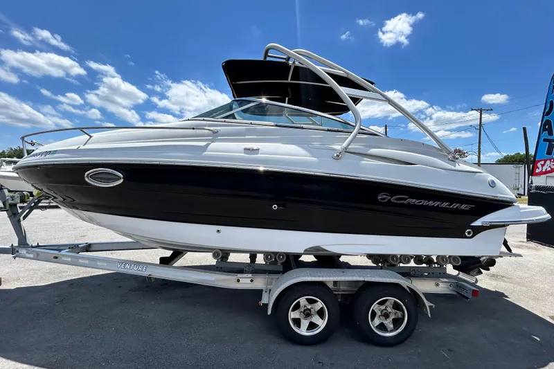 Slide: The Image of 2012 Crownline 236 SC boat on trailer under blue sky. - 8